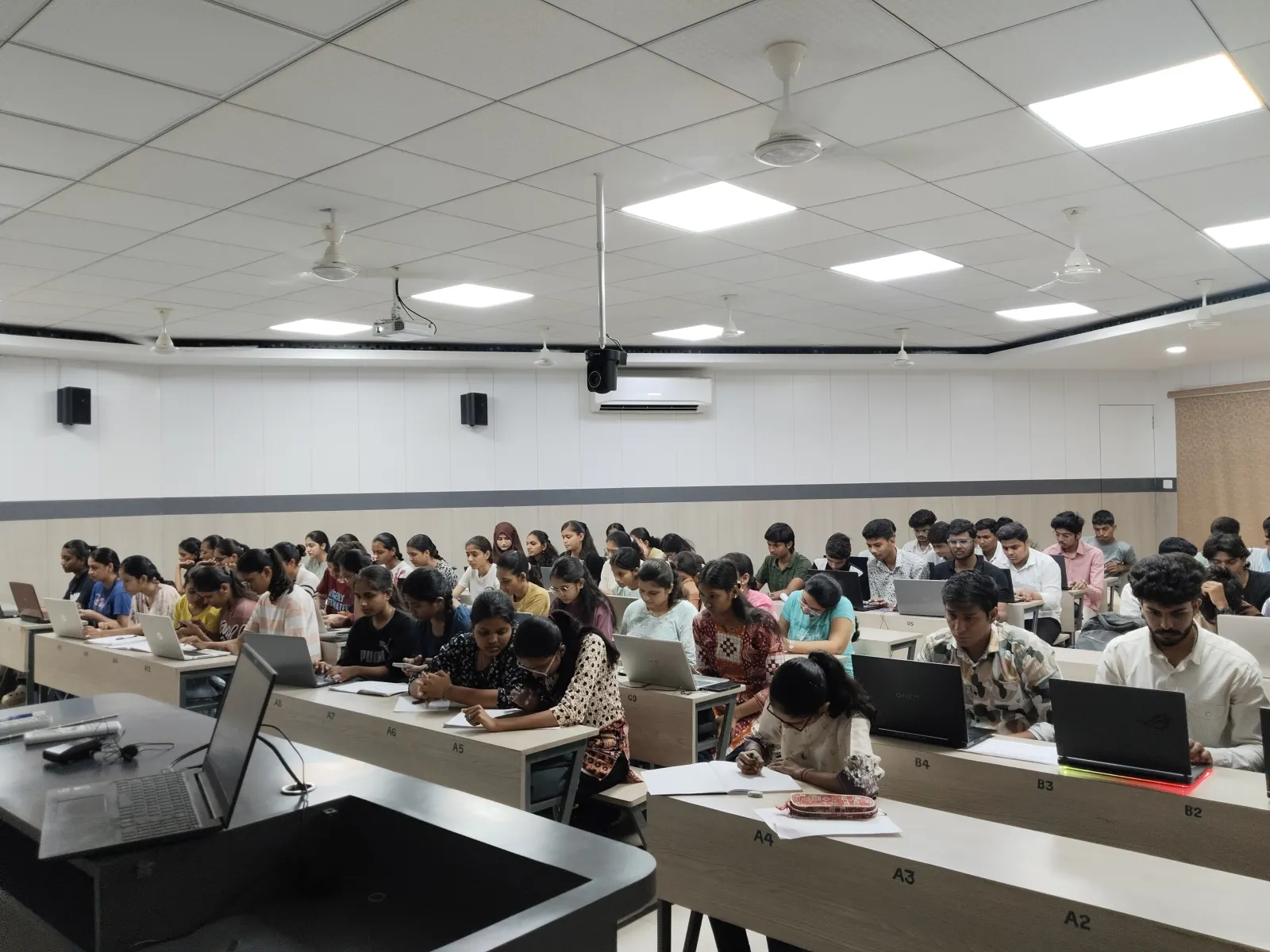 Full batch of students at workstations during a programming class at Info Planet