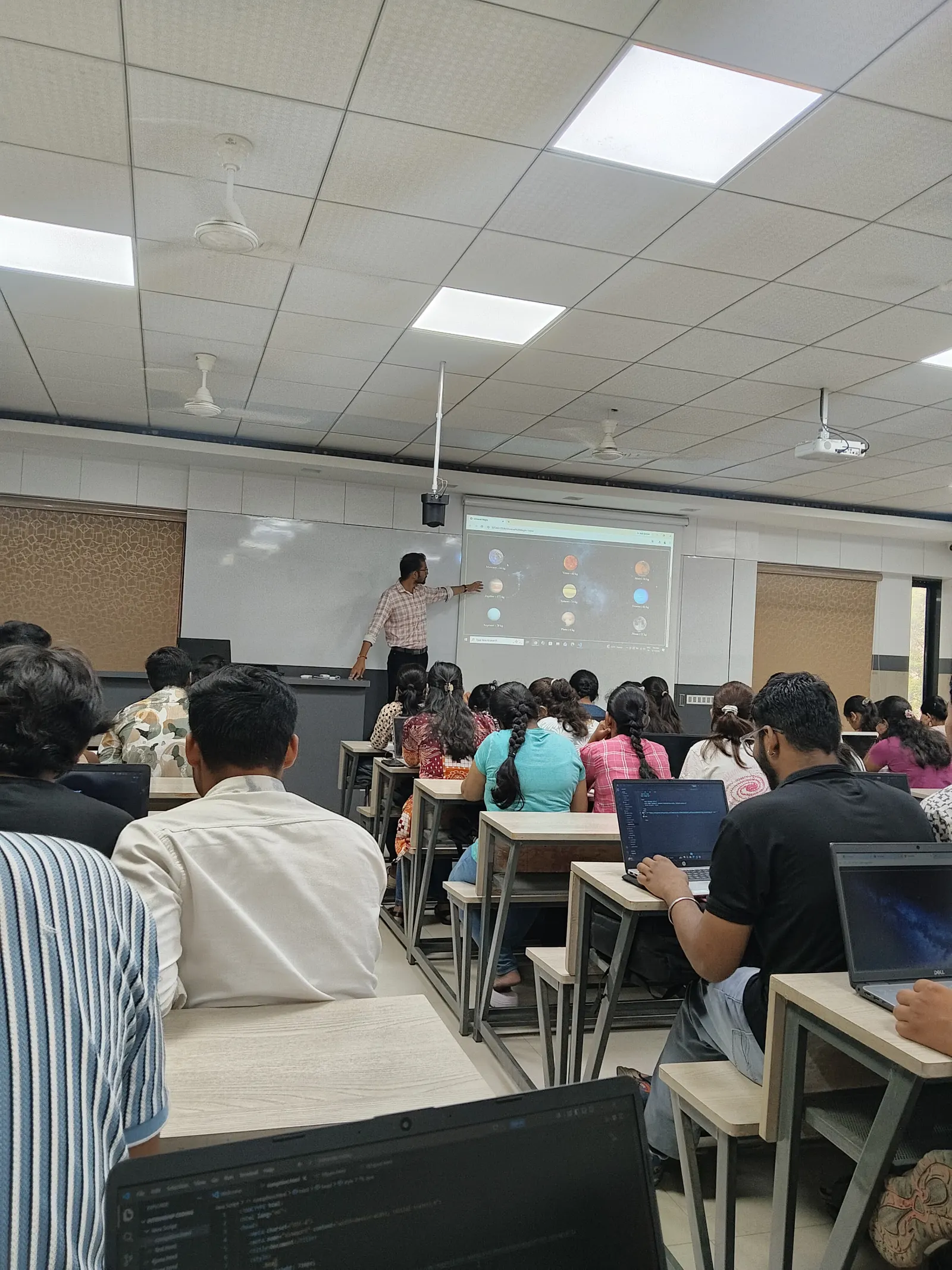 Atul Sir teaching a live coding session at the board, Info Planet
